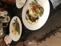 poached salmon with hollandaise on the left filet with demi and hollandaise